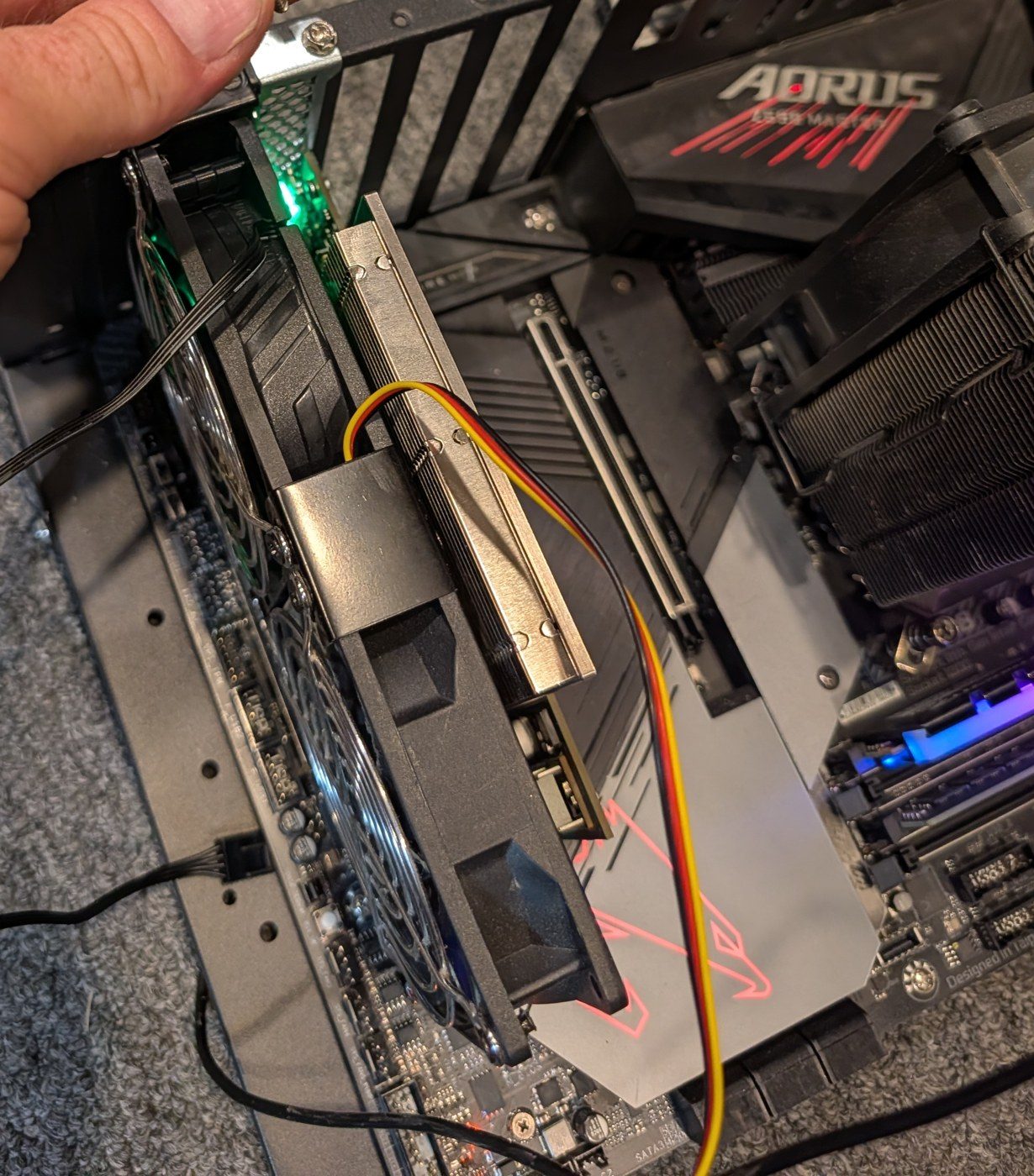 The bracket's two fans beside the powered card, whose green light is on; one fan has a 3-pin cable and one a black 4-pin cable.